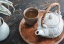 white and brown ceramic teapot on wooden tray