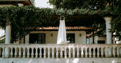 A white dress hanging on a leafy patio in Mariano Roque Alonso, Paraguay.