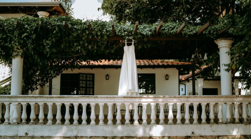 A white dress hanging on a leafy patio in Mariano Roque Alonso, Paraguay.